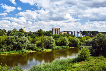 Trees and buildings on the Warta River in the city of Poznan