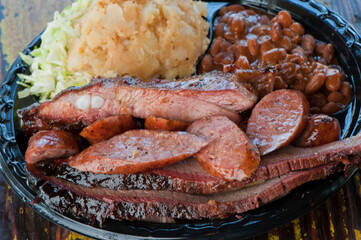 Brisket, pork sausage, pork ribs, beef ribs. Barbecue platter served with classic bbq sides Mac n cheese, cornbread, Brussels sprouts, coleslaw & beer. Classic traditional Texas meats & side dishes.