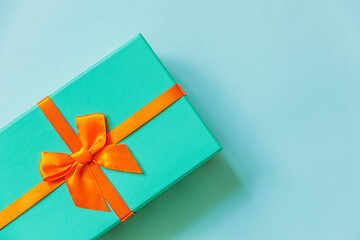 Christmas New Year birthday valentine celebration present romantic concept. Simply minimal design blue gift box isolated on pastel blue colorful background. Flat lay top view, copy space