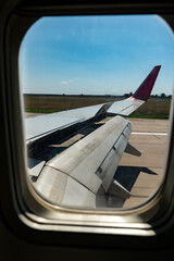 View from the airplane window on the wing with the flaps extended.