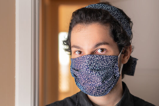 Close Up Of Fashionable Man With Mask And Head Band Looking At Camera. In Front Of Apartment Door. Individuality, Style, Identity, Coronavirus Or Covid-19 Quarantine Concept.