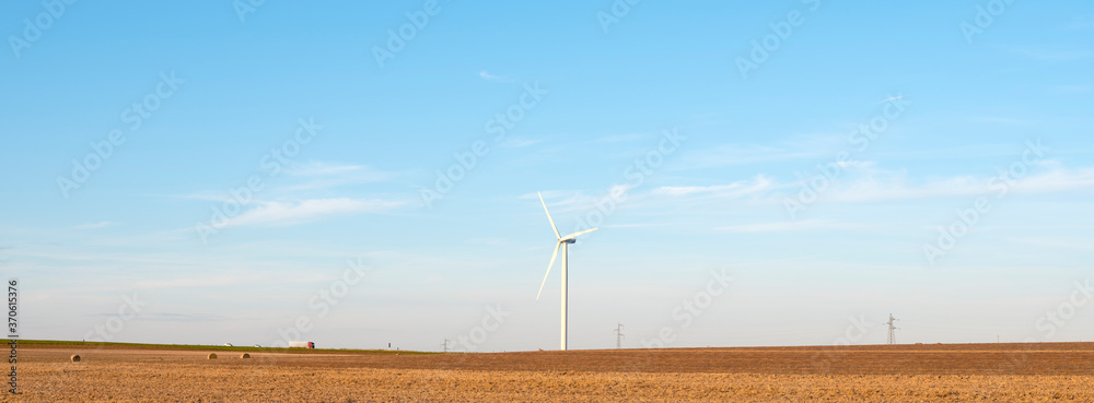 Poster fields after harvest in the north of france with wind turbines in the background