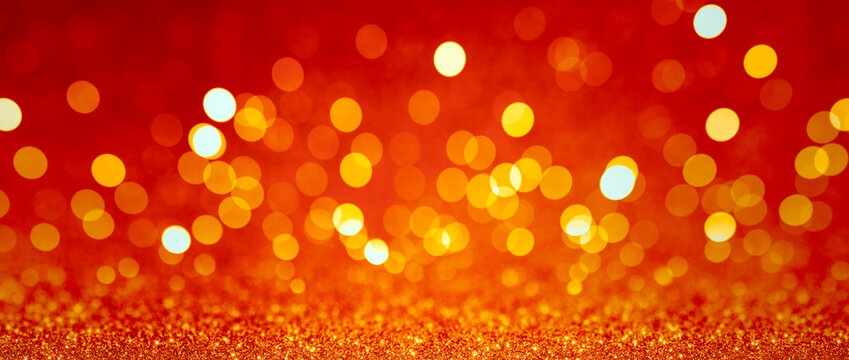 Abstract blurred background, yellow lights on red background. Golden christmas or new year bokeh.