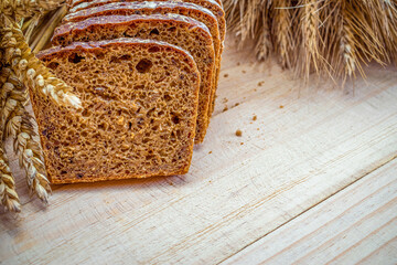 Delicious bread. Fresh loaf of rustic traditional bread with wheat grain ear or spike plant on...