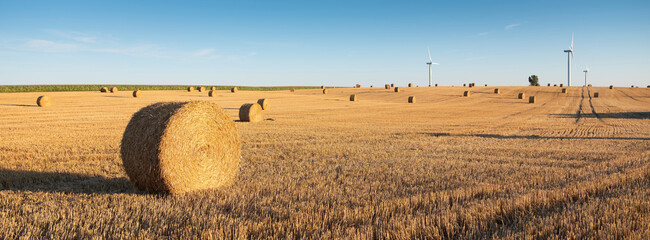 fields after harvest in the north of france with wind turbines in the background