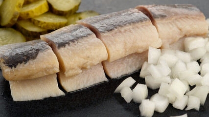 Holland Soused herring with onion and dill pickles cucumbers