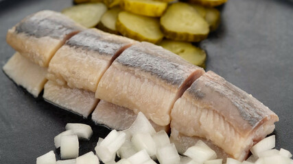 Holland Soused herring with onion and dill pickles cucumbers