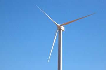 ветряная электWind Generator Turbine in Bright Sun Light on the Clear Blue Sky Background. High quality photo