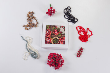 top view on white gift box with cotton scarf served with different bright accessories