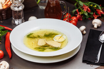 a white bowl filled with Delicious chicken noodle soup