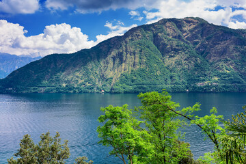 Fototapeta na wymiar Lake Como coastline, view of the lake and surrounding mountains