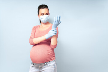 Yang woman put on blue gloves. Healthcare and Infection concept. Woman in Medical Face Mask and blue gloves against flu and viruses, copy space. High resolution.