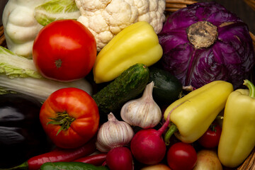 Different Organic Fruits and vegetables on wooden table back. Food background with assortment.