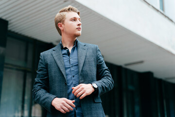 Portrait of young handsome man looking somewhere, city style.
