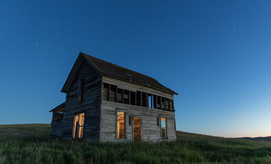 View of abandoned house on farm at dusk