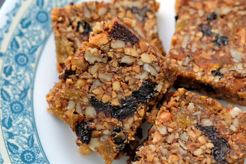Kozinaki with nuts, dried apricots, figs and raisins. Healthy snack made of nuts and nougat. A healthy vegetarian dish.