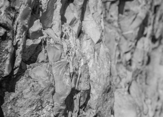 Ancient wall folded of natural rough stones, perspective view.