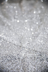 Obraz premium Close up picture of silver glitter with blur effect. White shade with sparkling effect on the background. Picture for wallpaper. Fabric closely with shimmering light. Abstract bokeh lights defocused 