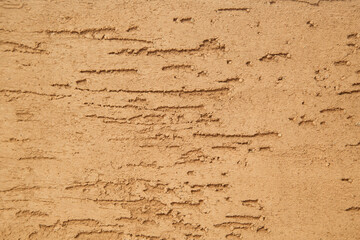 photo of an untreated wall in warm colors, cement coating. Texture