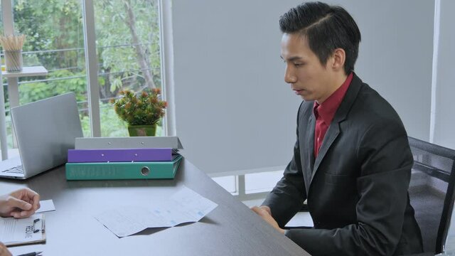 Employers have employees sign documents and give employees a letter of termination, Man in stress due to dismissal from work.