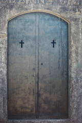 Old metal door with cross holes decorations