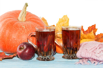 autumn background, pumpkin, apples with yellow leaves and tea in Cup on wooden table on white background.
