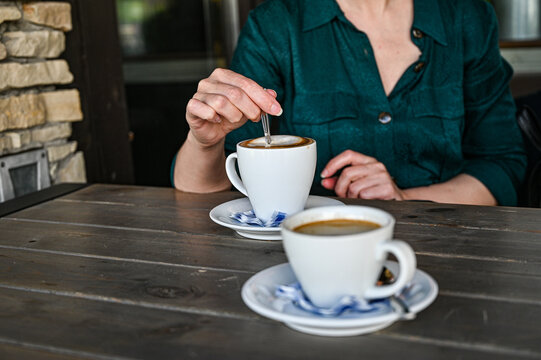 woman in a cafe drinking black coffee at the table in the morning.