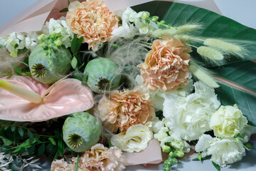 Close-up detail beautiful summer bouquet in bright colors, gray backdrop, selective focus