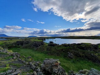 Fototapeta na wymiar Beautiful Icelandic summertime riverbank with plains and rocks, Iceland