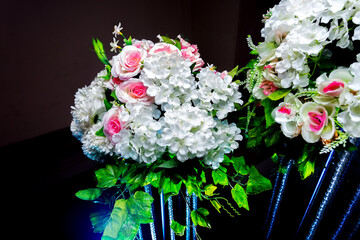 White and green color based artificial plastic flowers a bouquet. wedding decoration.