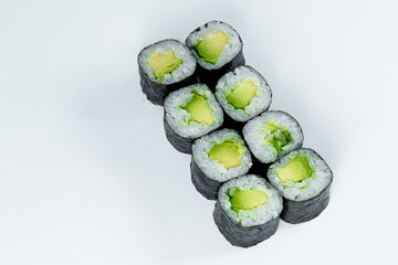 Japanese food. Rolls with ripe avocado, fresh rice with vegetables in nori. Vegetarian rolls