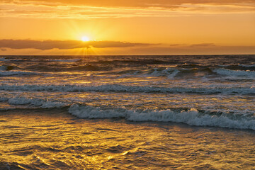 Obraz premium Sunset on Baltic Sea white bright golden orange color and rough sea