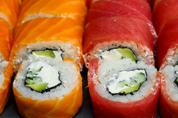 Japanese traditional food. Set of sushi rolls philadelphia with fresh salmon avocado and cream cheese and soy sauce
