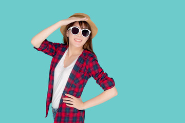 Beautiful portrait young asian woman wear sunglasses and hat smile excited and confident enjoy summer trip holiday isolated blue background, girl cheerful having backpack in vacation, travel concept.