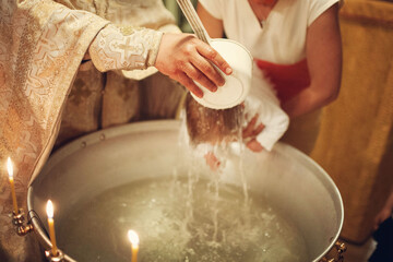 Orthodox Christian priest and little child in the church. Epiphany ceremony rite and font