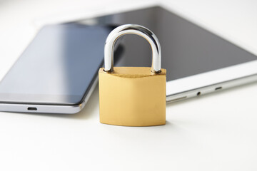 tablet pc and smartphone with padlock over white background. digital data security concept. virus protection software concept