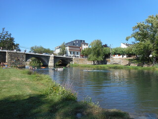 Fototapeta na wymiar Bridge over river in the old spain village