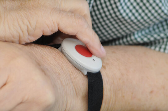 emergency button on wrist of an old woman