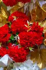 Colorful Red and golden flower and lighting wedding stage decoration. Plastic artificial flower. wedding decoration.