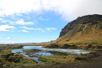 Beautiful green and yellow mountainside and river  in iceland 