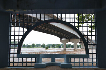 Fototapeta premium Arch frame around flooded river and bridge