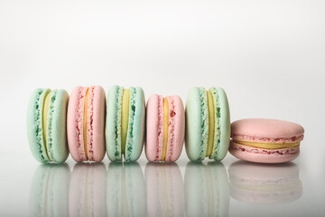 Row of many perfect colorful macarons on the natural background. Front view.