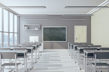 Fototapeta Light classroom interior with empty chalkboard obraz