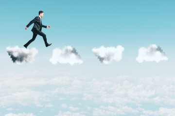 Fototapeta na wymiar Young businessman walking on clouds.