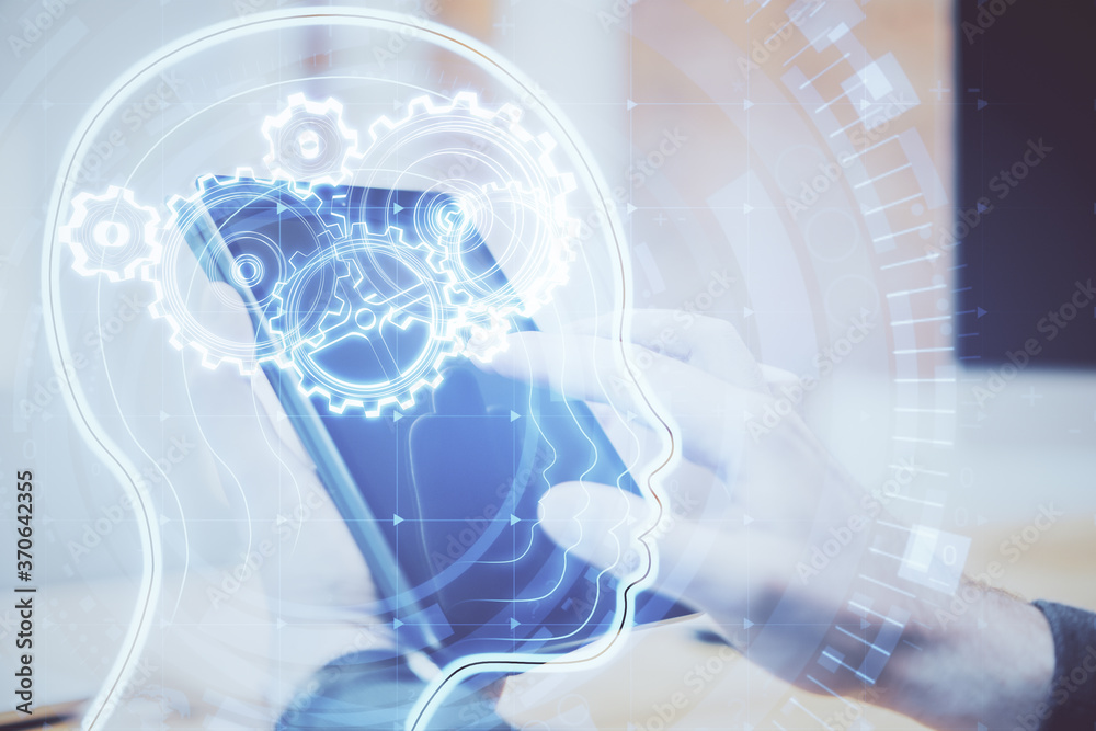Poster Hand using digital tablet and glowing head with cogs hologram.