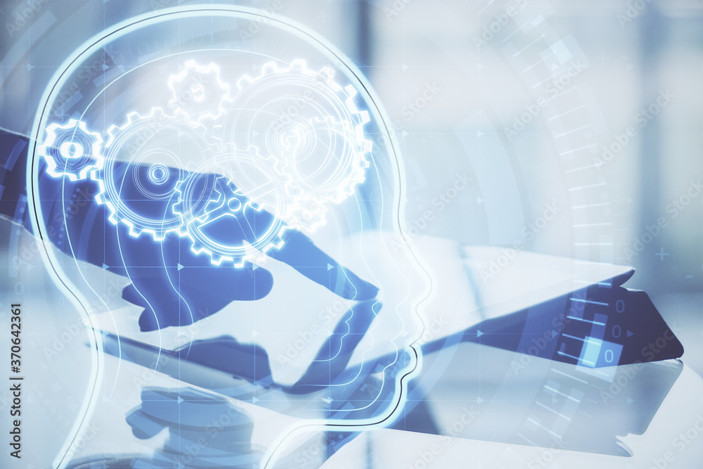 Aufkleber hand using tablet with glowing head with cogs.