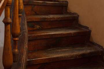 Fototapeta na wymiar Shabby steps of old wooden staircase with selective focus