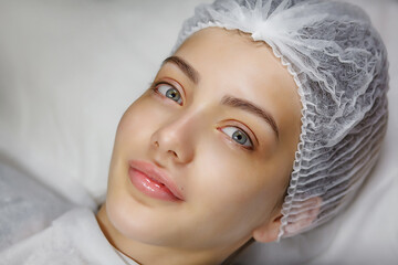 Beauty portrait of female face with natural skin. Beautiful young woman with clean fresh skin on face. Girl facial treatment. Cosmetology, beauty and spa.