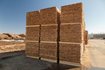 A pallet of boards in an industrial sawmill warehouse