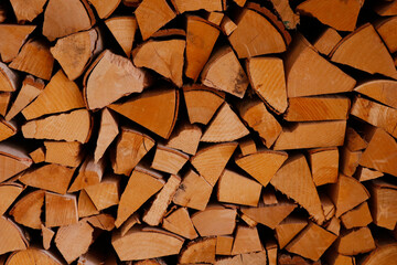 Stack of old firewood texture background.Fireplace wood, cordwood, splitwood.stored logs, wood and lumber